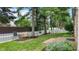 Spacious fenced in backyard with mature trees, bench, and swing set, creating a perfect place to relax at 1067 Acadia Ct, Indianapolis, IN 46217