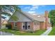 Brick home exterior featuring a patio, manicured lawn, and lovely landscaping at 1067 Acadia Ct, Indianapolis, IN 46217