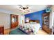 Charming bedroom with blue accent wall, hardwood floors, and vintage furniture at 1067 Acadia Ct, Indianapolis, IN 46217