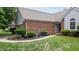 Charming home exterior with brick accents, manicured landscaping, and a well-kept lawn at 1067 Acadia Ct, Indianapolis, IN 46217
