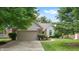 Brick home exterior with an attached garage, lush lawn and flowerbeds at 1067 Acadia Ct, Indianapolis, IN 46217