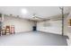 Spacious garage with an automatic door opener, painted floor, and ample room for vehicles at 1067 Acadia Ct, Indianapolis, IN 46217