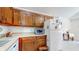 An organized kitchen with ample wood cabinetry, white appliances, and neutral countertops at 1067 Acadia Ct, Indianapolis, IN 46217