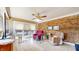 Cozy and bright sun room, features light colored flooring, brick accent wall and sliding glass doors at 1067 Acadia Ct, Indianapolis, IN 46217