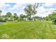 Expansive backyard with lush green grass, mature trees, and a charming home with raised garden beds at 1130 E 105Th St, Carmel, IN 46280