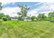 Extensive backyard with mature trees, showcasing the property's size and potential for outdoor enjoyment at 1130 E 105Th St, Carmel, IN 46280