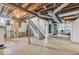 Spacious unfinished basement with exposed utilities, stairs, and a laundry area, providing ample storage or customization potential at 1130 E 105Th St, Carmel, IN 46280