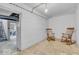 Inviting basement seating area with two rocking chairs and a view of the stairs, creating a cozy retreat space at 1130 E 105Th St, Carmel, IN 46280