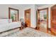 Bright bedroom featuring a daybed, wood trim, and an open doorway to another room, creating a warm, inviting atmosphere at 1130 E 105Th St, Carmel, IN 46280