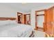 Well-lit bedroom showcasing a bed with a decorative headboard, wood trim and doorway to a closet at 1130 E 105Th St, Carmel, IN 46280