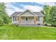 Home featuring a welcoming porch with brick supports enhancing the home's curb appeal at 1130 E 105Th St, Carmel, IN 46280