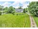 Charming home with a large front lawn, mature trees, and a gravel driveway offers great curb appeal at 1130 E 105Th St, Carmel, IN 46280