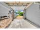 View of an attached garage with an open door and a partial view of the backyard at 1130 E 105Th St, Carmel, IN 46280