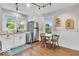 Charming kitchen featuring white cabinets, stainless appliances, and a cozy breakfast nook at 1130 E 105Th St, Carmel, IN 46280
