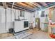 Functional laundry area with a washer and dryer, utility sink, and storage shelves, designed for convenience and organization at 1130 E 105Th St, Carmel, IN 46280