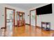 Bright living room featuring hardwood floors, large TV, and classic furnishings at 1130 E 105Th St, Carmel, IN 46280