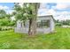 Charming outbuilding with a picket fence and mature tree, ideal for a workshop or extra storage at 1130 E 105Th St, Carmel, IN 46280