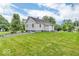 Rear exterior shot highlighting the home's siding, windows, and well-maintained lawn at 1130 E 105Th St, Carmel, IN 46280