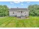 Rear exterior displaying a small back deck and a well maintained lawn at 1130 E 105Th St, Carmel, IN 46280