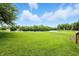 Expansive green lawn extending to a serene lake, perfect for enjoying nature and outdoor activities at 1326 Pebble Brook Dr, Noblesville, IN 46062