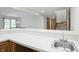 Close-up of the basement bar featuring a sink, white countertop, and views of the open recreation area at 1326 Pebble Brook Dr, Noblesville, IN 46062