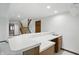Basement bar area with a white countertop and wood cabinets, open to staircase and additional living space at 1326 Pebble Brook Dr, Noblesville, IN 46062