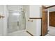 Tiled bathroom with glass-enclosed shower and wood accents, offering a clean and functional space at 1326 Pebble Brook Dr, Noblesville, IN 46062