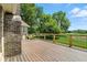 Wood deck overlooking the well maintained grass and large green trees at 1326 Pebble Brook Dr, Noblesville, IN 46062