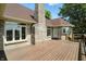 Spacious wooden deck showcasing a brick exterior and scenic backyard at 1326 Pebble Brook Dr, Noblesville, IN 46062