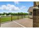A spacious deck with a metal railing that offers picturesque water and green landscape views at 1326 Pebble Brook Dr, Noblesville, IN 46062