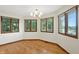 The bright dining room offers hardwood floors and views of the yard through the multi-pane windows at 1326 Pebble Brook Dr, Noblesville, IN 46062