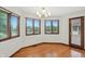 Dining room features hardwood floors, chandelier, bright windows, and a door that leads to the deck at 1326 Pebble Brook Dr, Noblesville, IN 46062