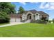 Charming brick home featuring a well-manicured lawn and a two-car garage with beautiful shrubbery at 1326 Pebble Brook Dr, Noblesville, IN 46062
