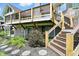 Multi-level deck with wood railings and stairs leading to the landscaped backyard at 1326 Pebble Brook Dr, Noblesville, IN 46062