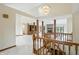 Bright foyer features marble floors, a stylish chandelier, and a wooden staircase leading to open living spaces at 1326 Pebble Brook Dr, Noblesville, IN 46062