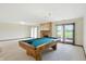 Spacious game room with a pool table, brick fireplace, and sliding glass doors leading to the outside at 1326 Pebble Brook Dr, Noblesville, IN 46062