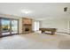 Bright game room with a pool table, brick fireplace, and sliding glass doors offering natural light at 1326 Pebble Brook Dr, Noblesville, IN 46062