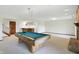 Open game room area with a pool table, brick fireplace, and bar, perfect for entertaining at 1326 Pebble Brook Dr, Noblesville, IN 46062