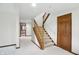 Bright hallway with carpeted stairs and wooden railings leading to the upper level at 1326 Pebble Brook Dr, Noblesville, IN 46062