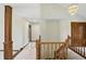 Hallway featuring marble floors and a staircase with wood railing at 1326 Pebble Brook Dr, Noblesville, IN 46062