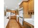 Kitchen features wood cabinetry, stainless appliances, and oversized island with breakfast bar and hardwood floors at 1326 Pebble Brook Dr, Noblesville, IN 46062
