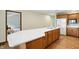 Kitchen features wood cabinets, stainless refrigerator, large island with cooktop, and hardwood floors at 1326 Pebble Brook Dr, Noblesville, IN 46062