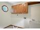 Functional laundry room with storage cabinets and a utility sink at 1326 Pebble Brook Dr, Noblesville, IN 46062