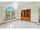 Bright living room with soaring ceilings, large window seat, and built-in shelving at 1326 Pebble Brook Dr, Noblesville, IN 46062