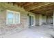 Covered patio with brick walls, concrete flooring, and access to the backyard at 1326 Pebble Brook Dr, Noblesville, IN 46062
