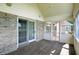 Covered patio with brick accents, wood flooring, and access to the backyard at 1326 Pebble Brook Dr, Noblesville, IN 46062