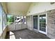 Enclosed patio with natural light, brick walls, and access to the backyard at 1326 Pebble Brook Dr, Noblesville, IN 46062
