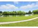 Picturesque view of a calm pond surrounded by mature trees and vibrant greenery at 1326 Pebble Brook Dr, Noblesville, IN 46062
