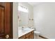 Powder room with a wood vanity, white sink, updated fixtures, and tile flooring for convenience at 1326 Pebble Brook Dr, Noblesville, IN 46062