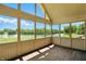 Bright sunroom with walls of windows offering stunning lake and golf course views at 1326 Pebble Brook Dr, Noblesville, IN 46062